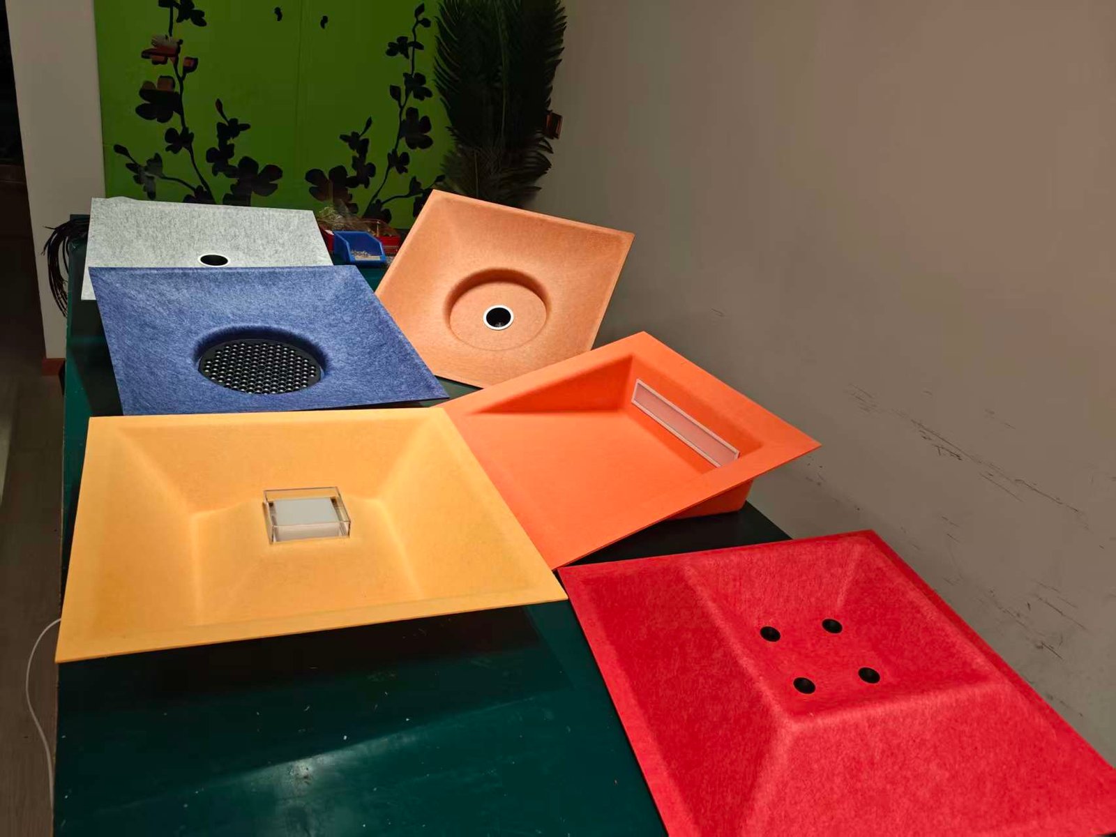 Colored PET felt samples with round, square and linear openings