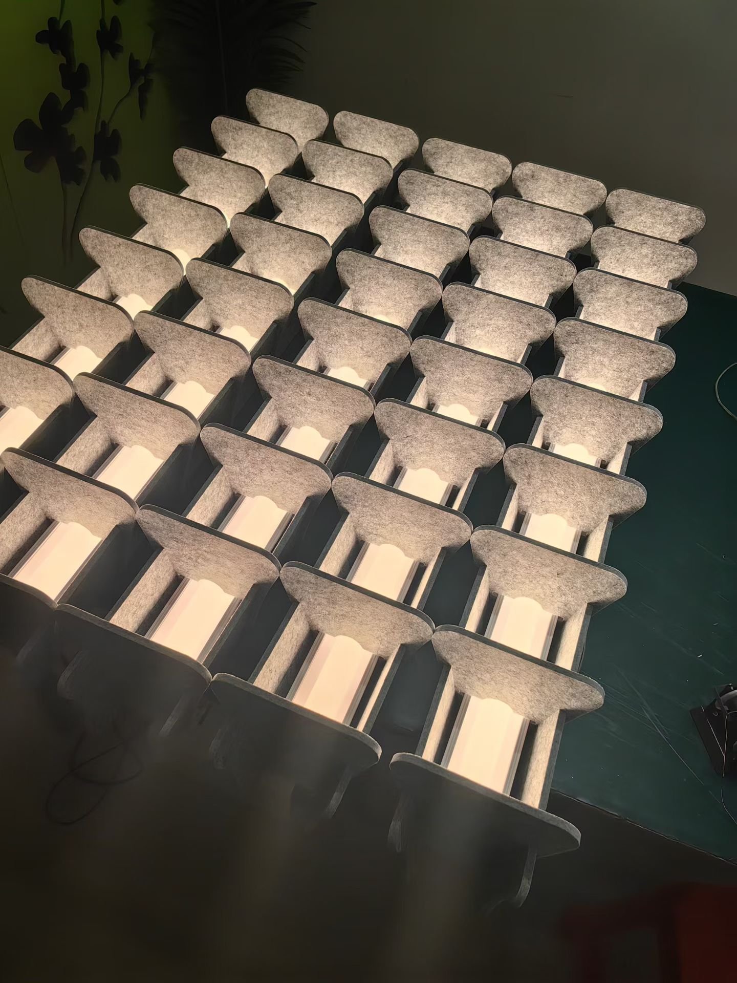 Illuminated grey felt grid showing fin spacing and diffuser arrangement