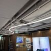 Curved 330° silicone tube with aluminium profile installed as a suspended architectural ceiling feature