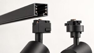 Original technical illustration of a black track rail cross-section and two different track-light adapters for compatibility checking.